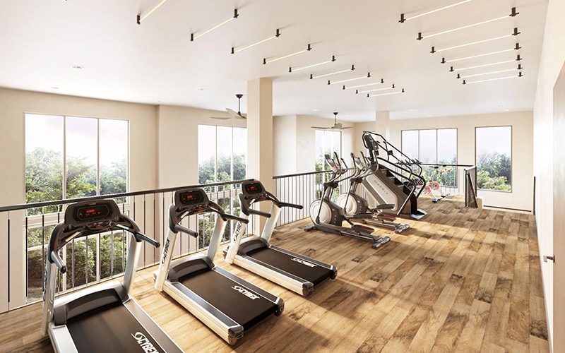 Large fitness center with plenty of equipment and large windows 